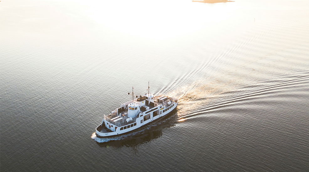A drone shot of a cruise ship making its way across the sea during sunset